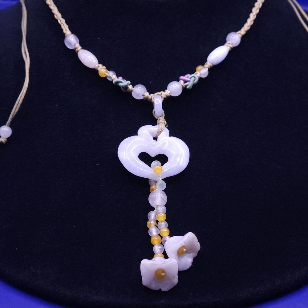 Carved jadeite heart pendant with floral and yellow jade bead accents